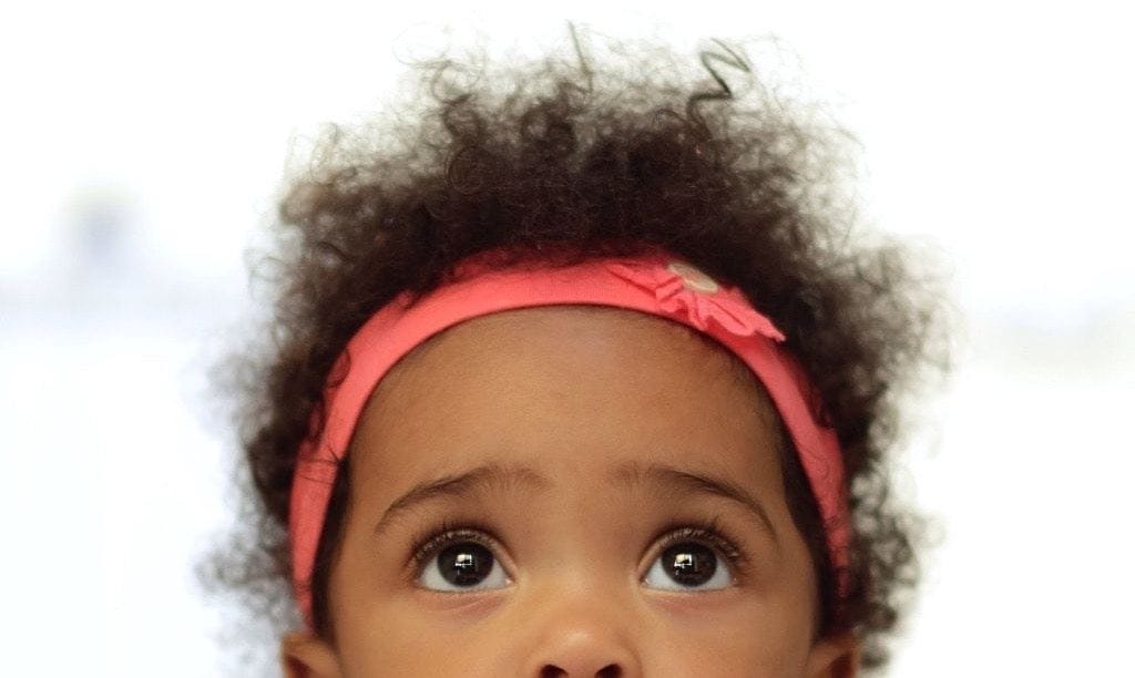 10 reasons why 2-year-olds are magical (not terrible) little girl wearing a headband and looking up
