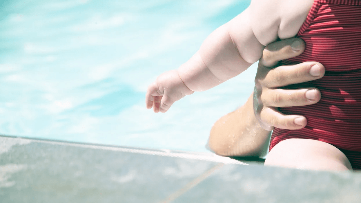 What parents need to know about ‘dry drowning’ & infant water safety mom holding infant in a pool