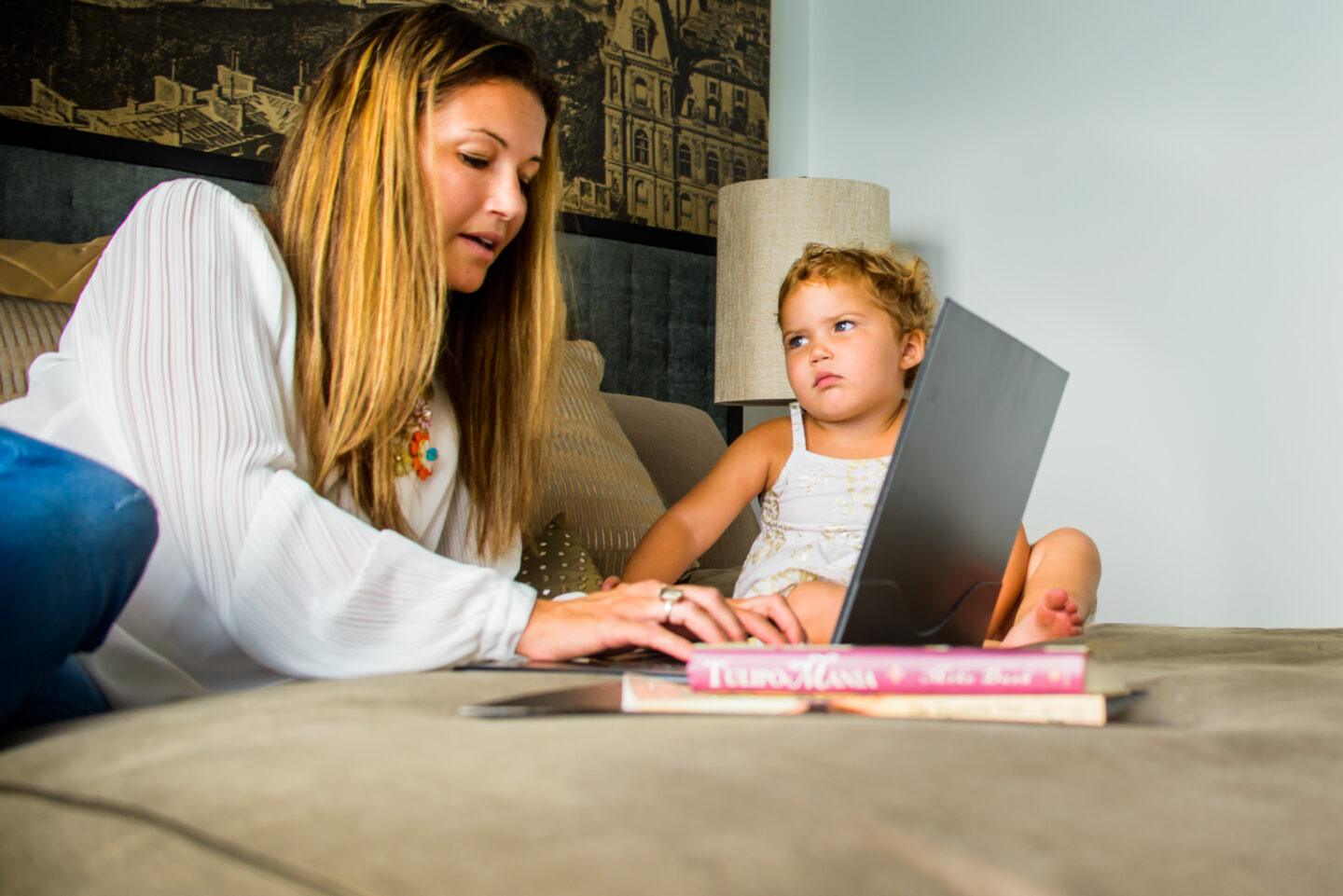 Live to work or work to live? How I put my career in perspective working mom on computer with toddler