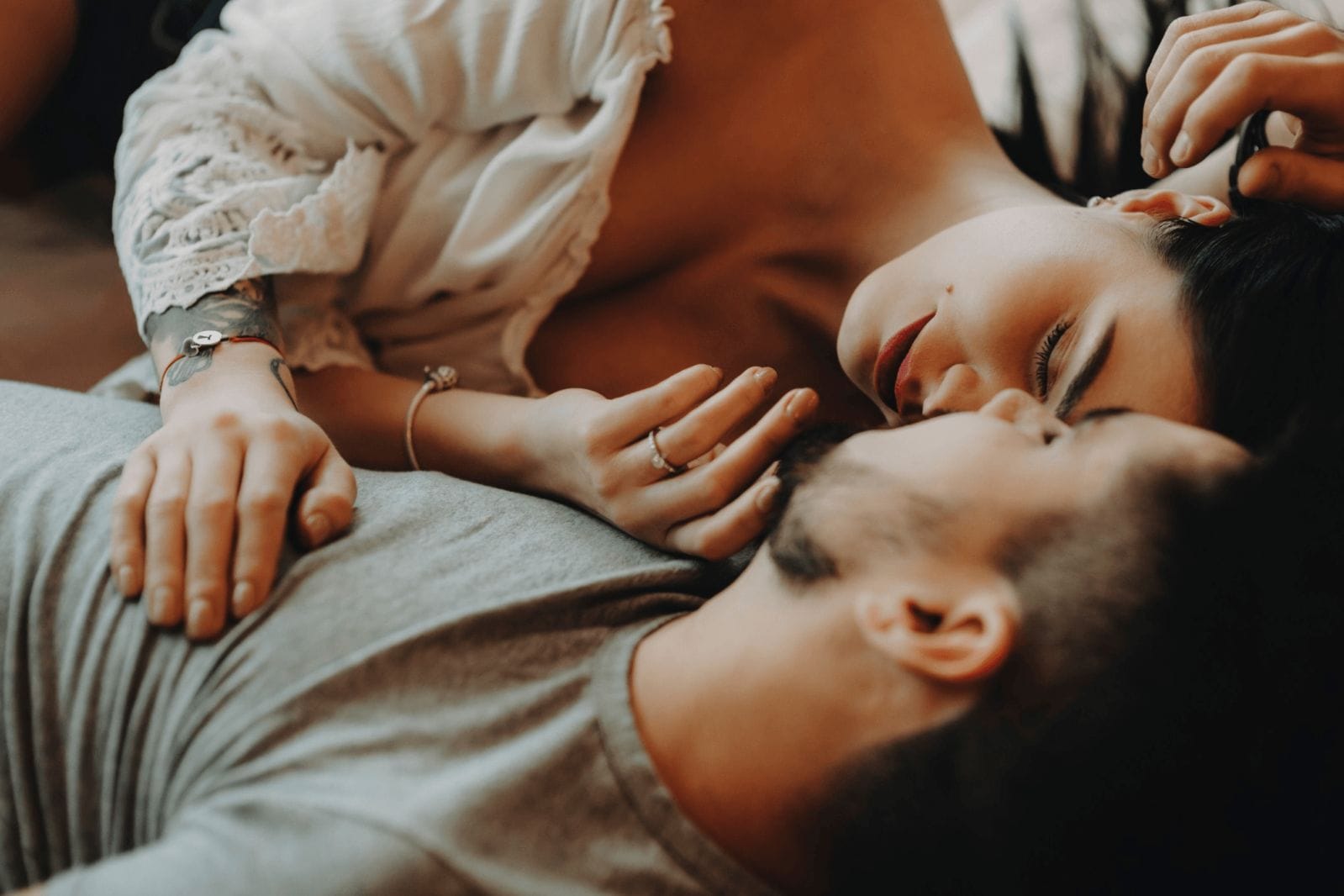I’m ready for a baby, he’s not (yet)—7 steps to talk through it together couple snuggling in bed together