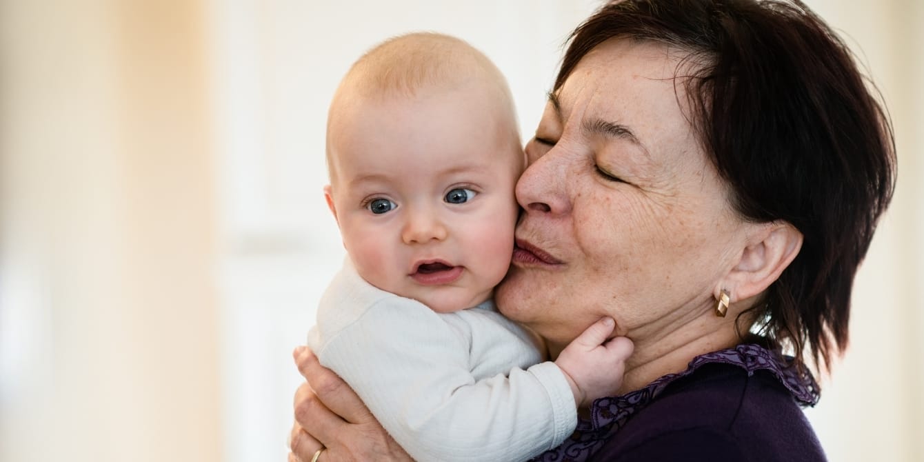 6 common in-law conflicts after baby arrives: How to handle them grandma kissing baby on cheek- grandparent boundaries