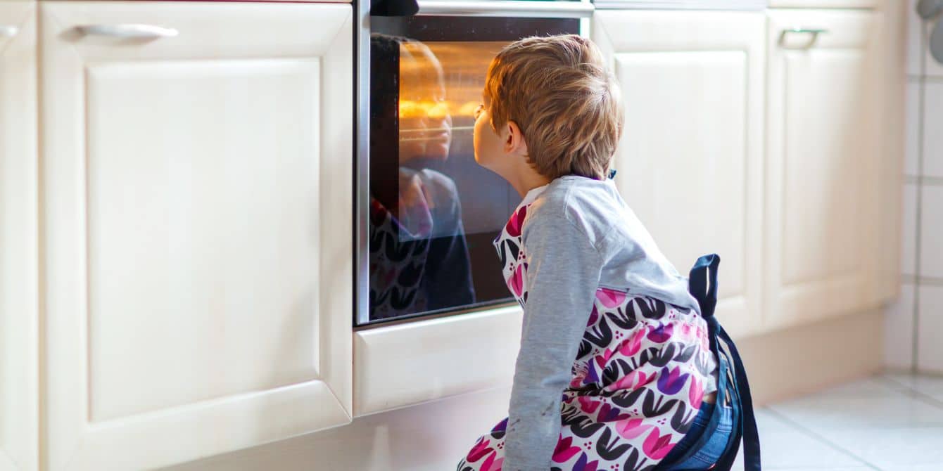 Simple (and safe!) ways kids can help with Thanksgiving prep Child helping with thanksgiving prep at oven