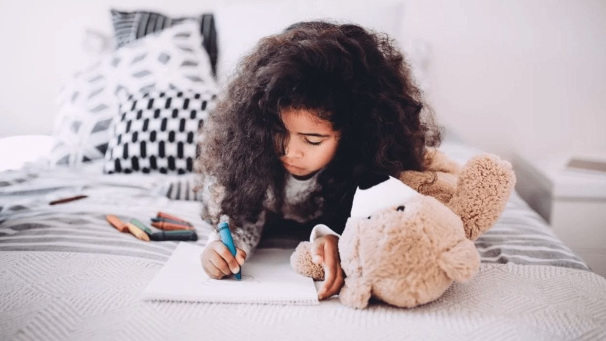 We quit screen time completely—and it saved our kids little girl coloring on her bed