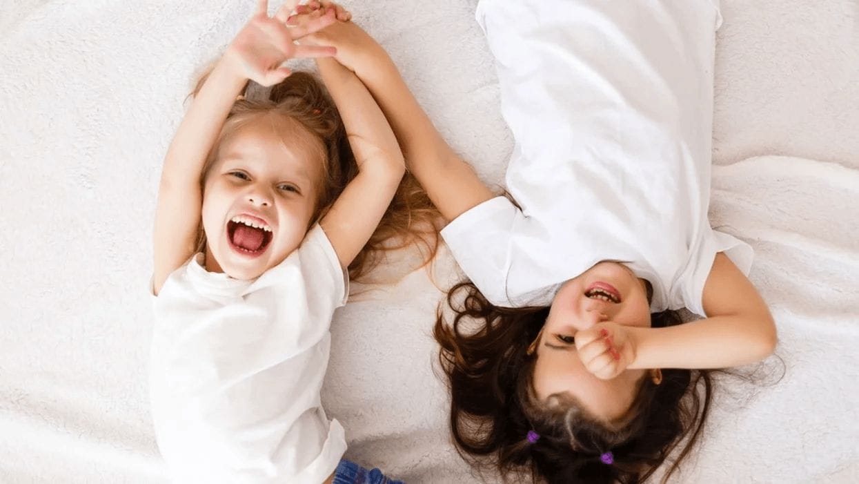 It’s science: Having sisters helps you become a better person sisters playing on a bed together