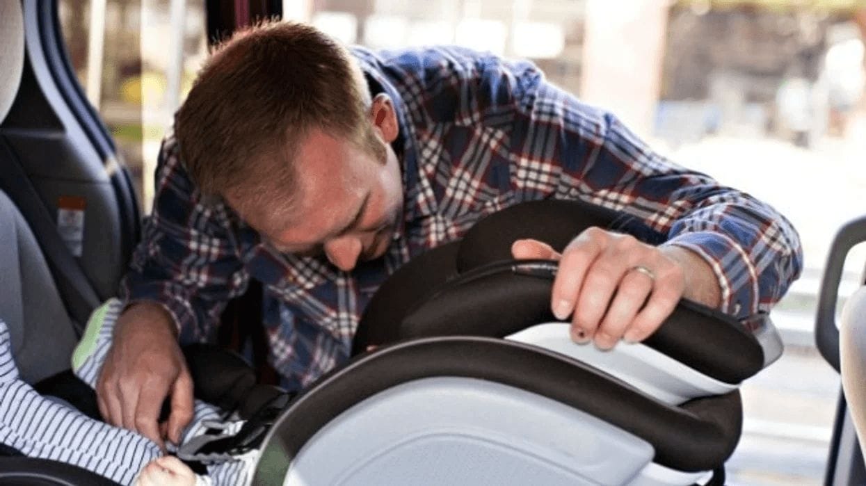 7 essential car seat safety tips for NICU babies dad putting a car seat in the car