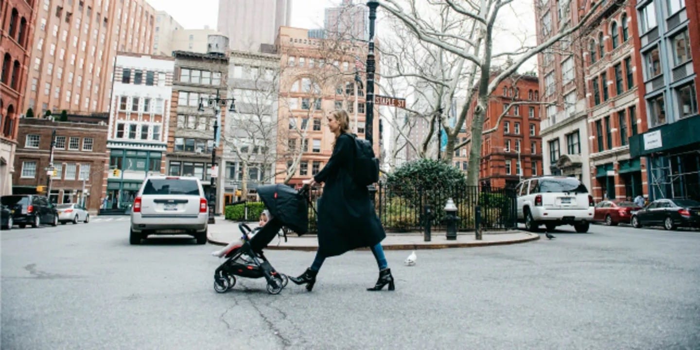 15 Pieces of Gear You Need for Traveling with a Baby mom walking a baby in a stroller