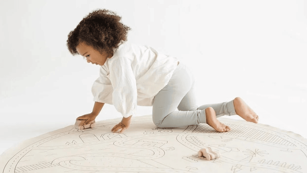 16 minimalist baby brands you need to follow on Instagram—now little girl playing on a gathre mat