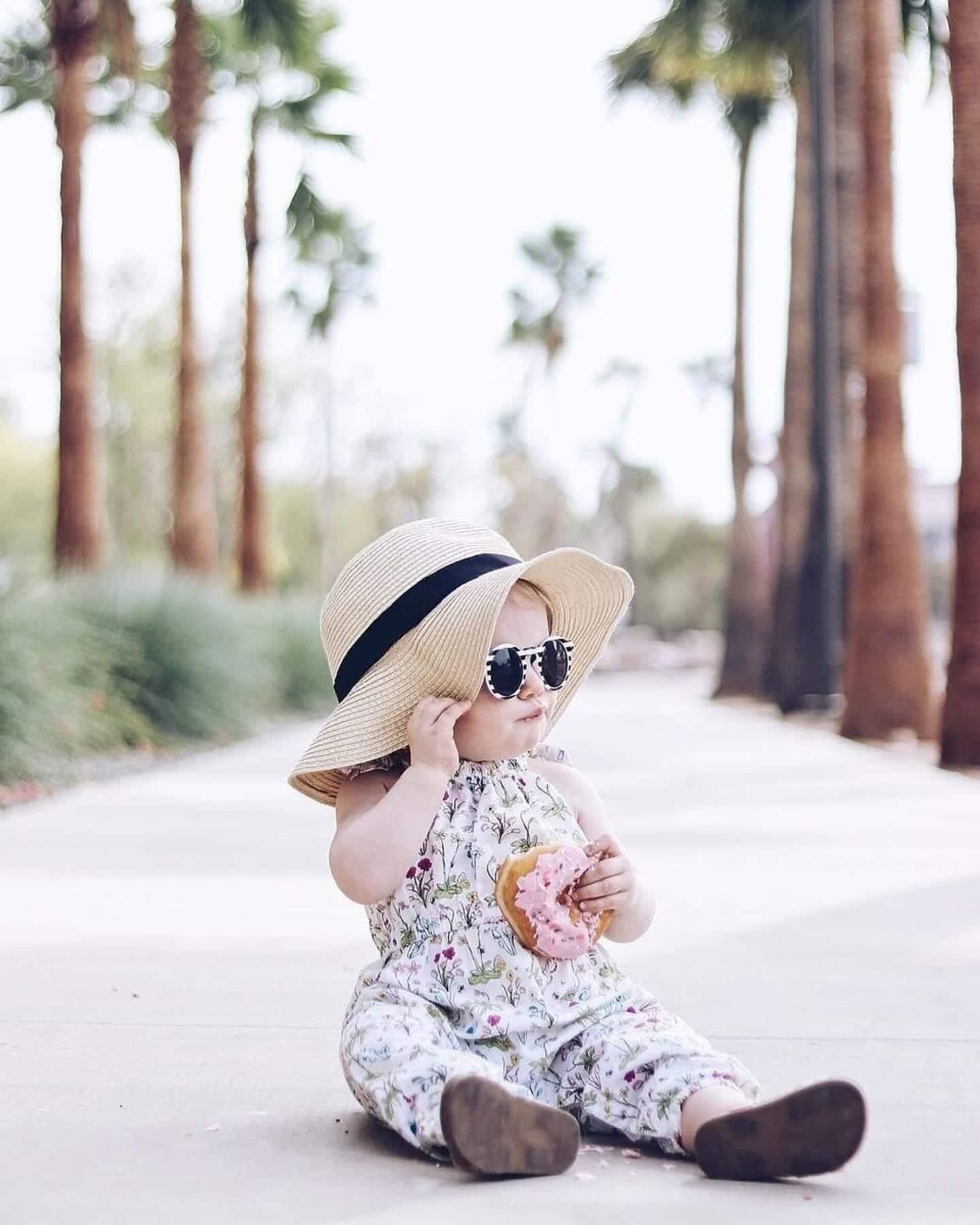 Other countries put a ban on certain baby names—but anything goes in the USA baby wearing a hat and eating a donut