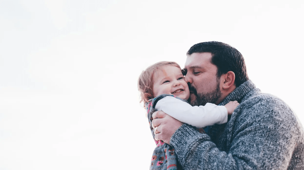 To my husband: You were born to raise a daughter dad kissing daughter on the cheek