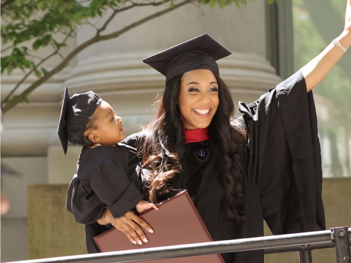 These mamas graduating with their babies are a true inspiration 👏 woman and baby wearing graduation toga