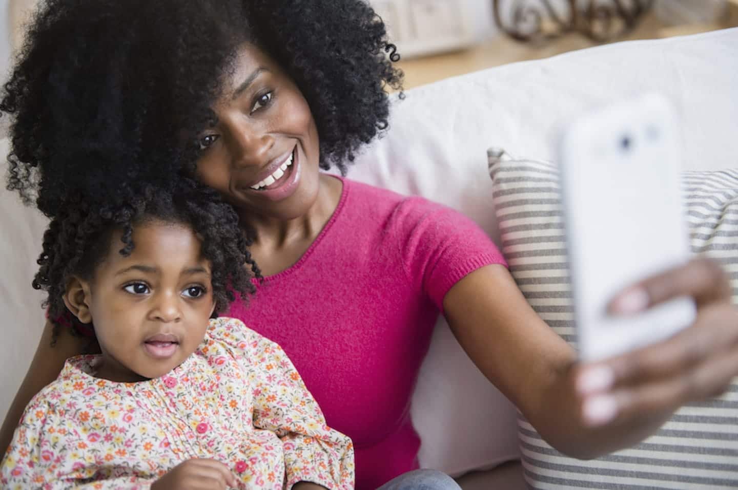 FaceTiming ALL the grandparents is about to get so much easier mom and her daughter holding a phone