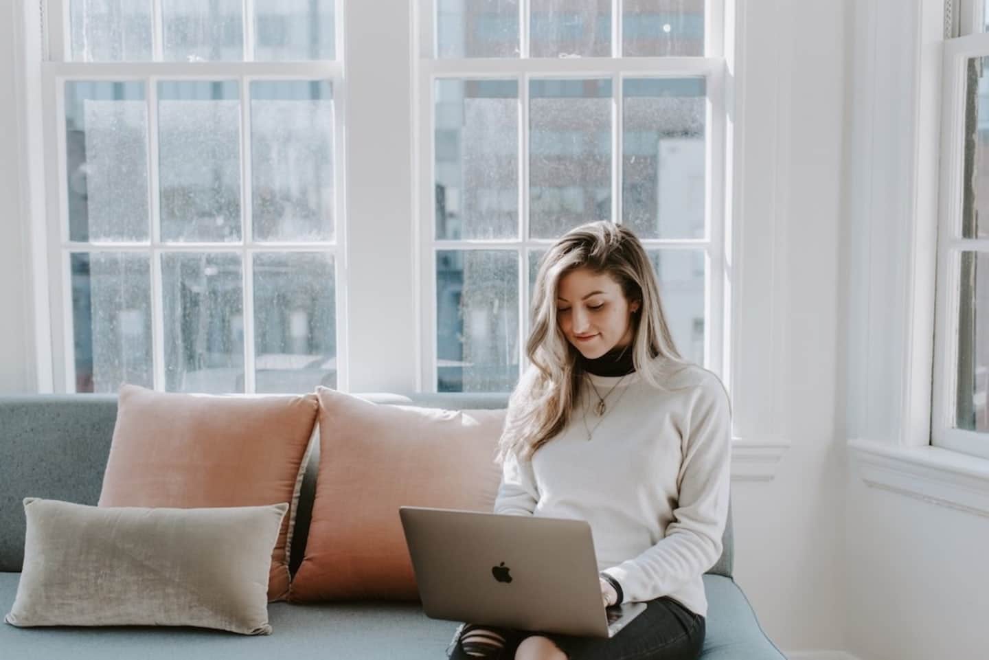 Amazon Prime Day isn’t the only deal right now, mamas woman sitting near the window using her mac book