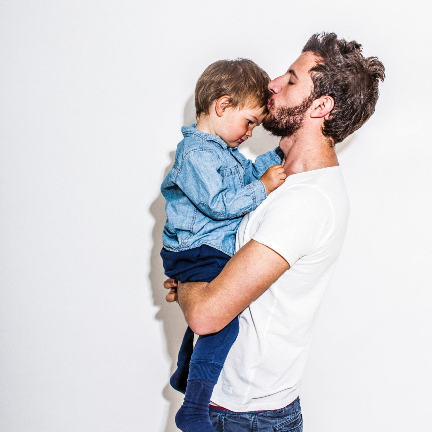 9 actions to take when your child misbehaves—that have nothing to do with punishment man carrying and kissing child's forehead