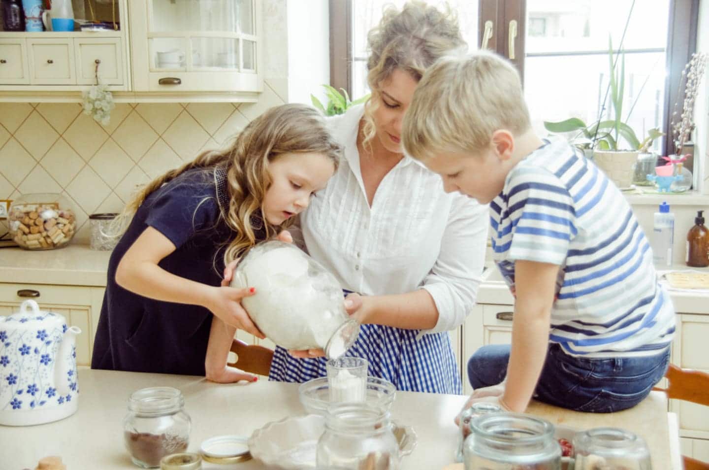 10 ways to parent like an Austrian—where trust goes a long way, mama Mom pouring milk with 2 children