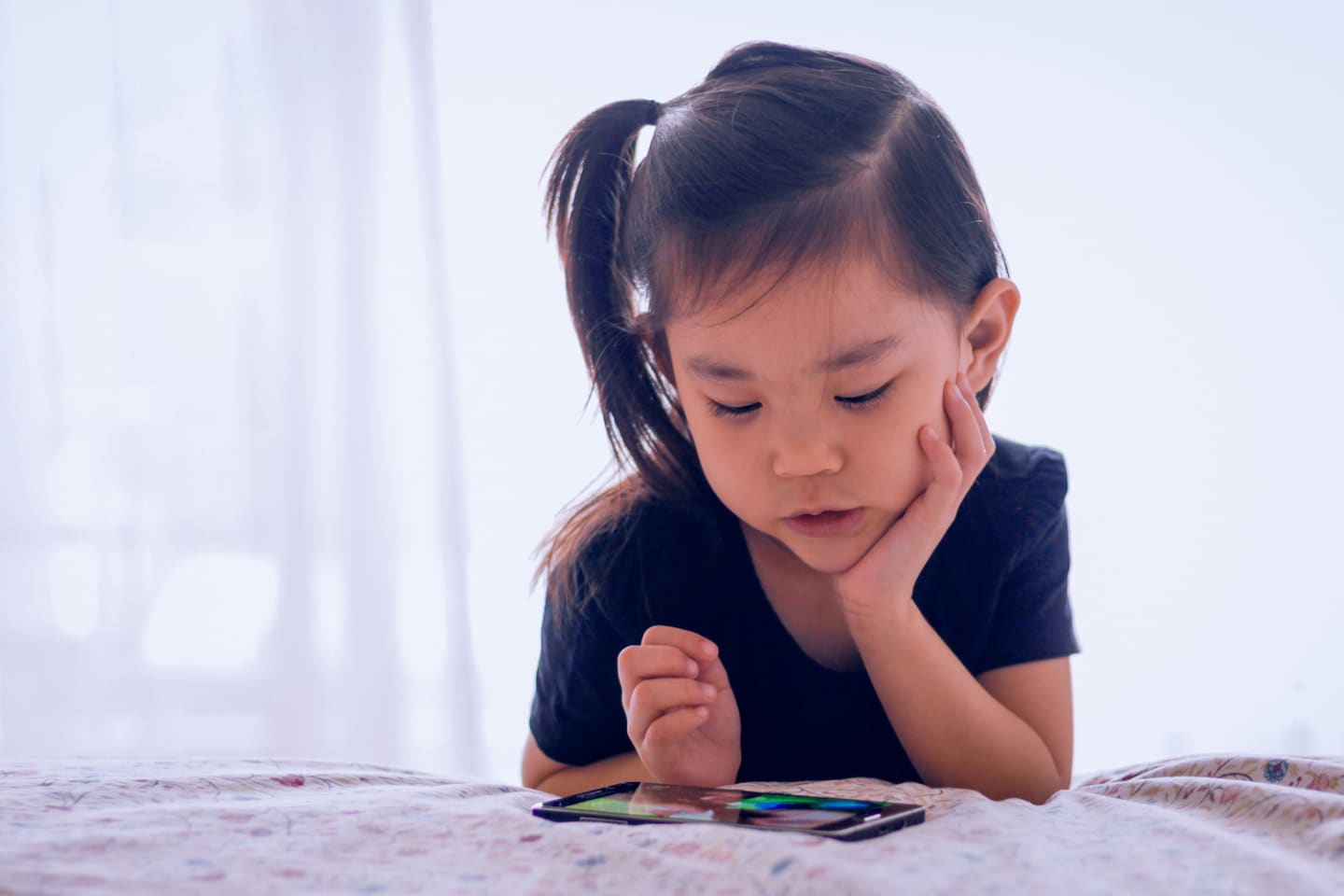 When your preschooler wants to watch TV *all* the time—7 tips for managing their screen time child watching on a cellphone