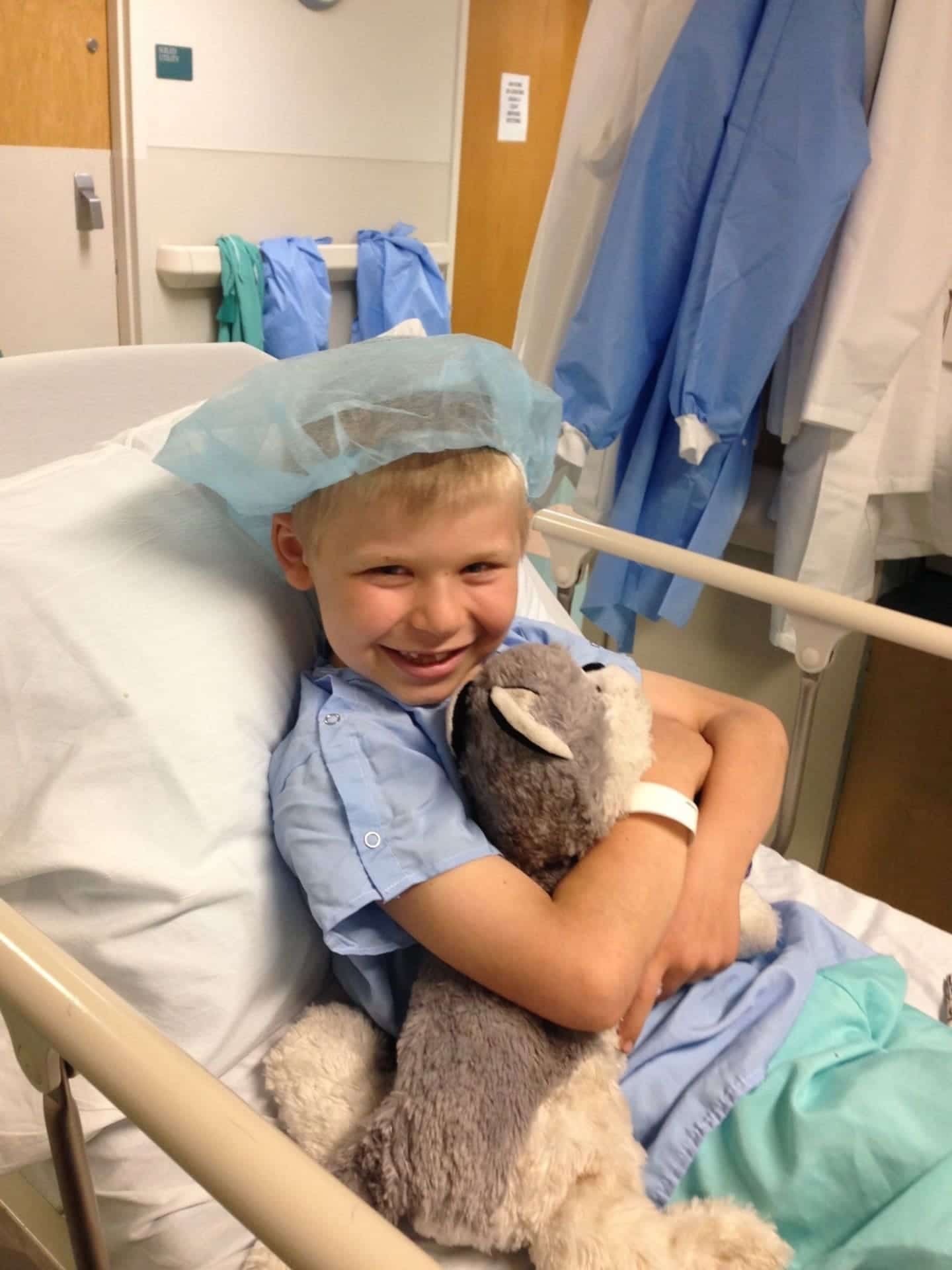 9 tips + tricks to prepare for your child’s surgery Child wearing hospital gown