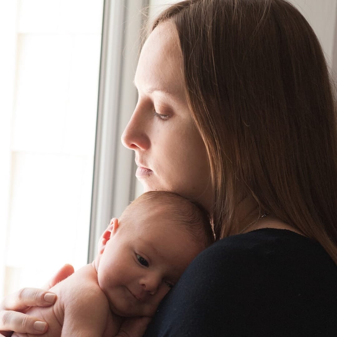Jen on accepting herself as a medicated mommy mom holding baby against her shoulder - postpartum depression essay