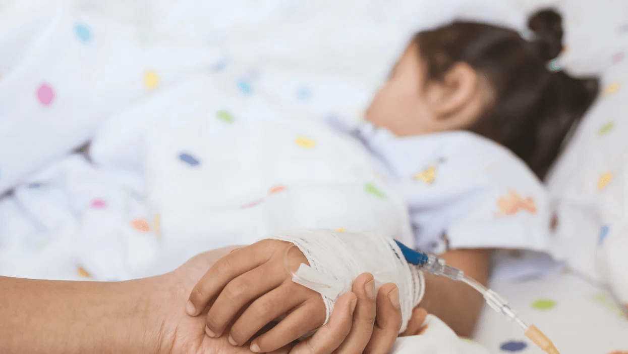 Why one mother is calling for better post-op monitoring for kids person holding child's hand in a hospital bed