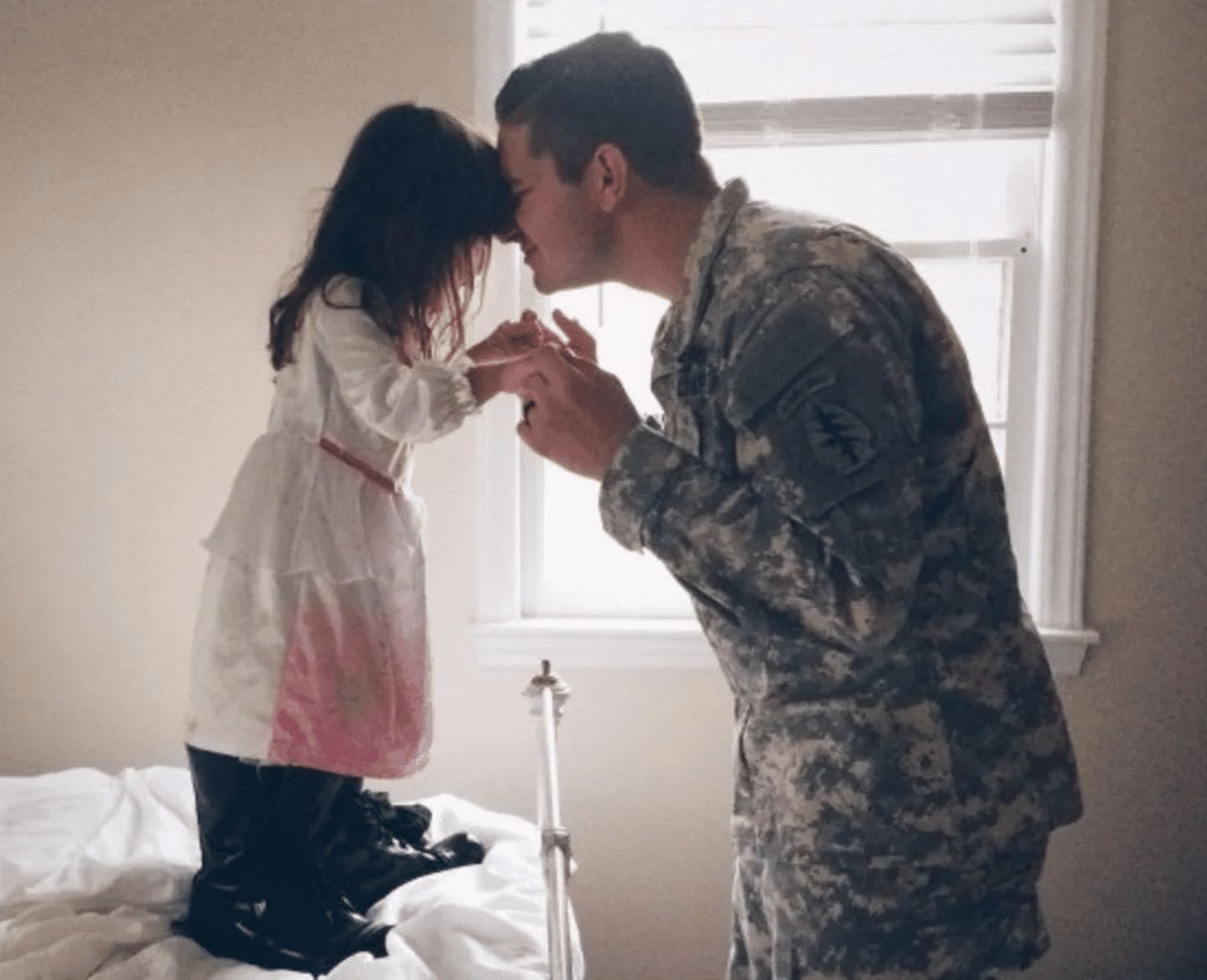 I’m a military wife and mom—and I’m so lucky military dad kissing daughter