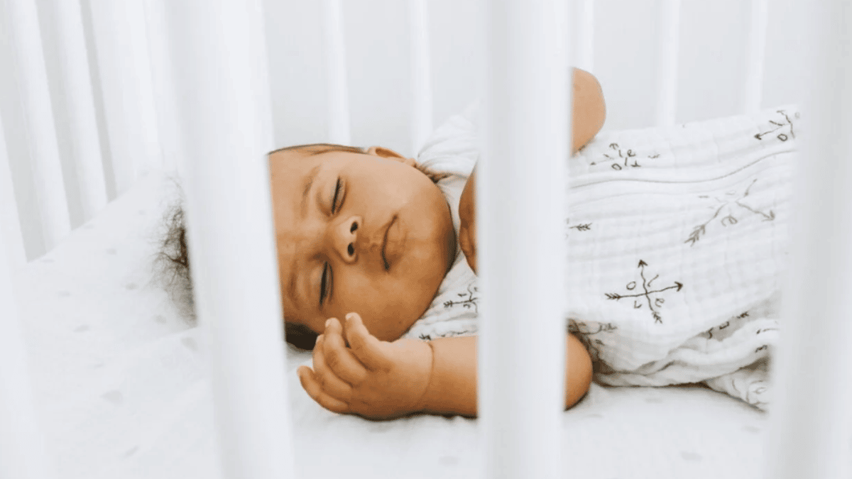 Many babies don’t sleep through the night as soon as parents expect, study says baby sleeping in a crib