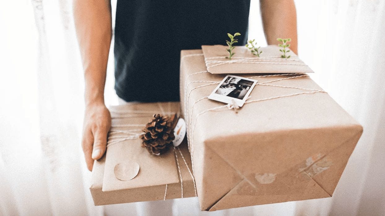 16 great holiday gifts that will earn you brownie points with new dads dad carrying wrapped gifts