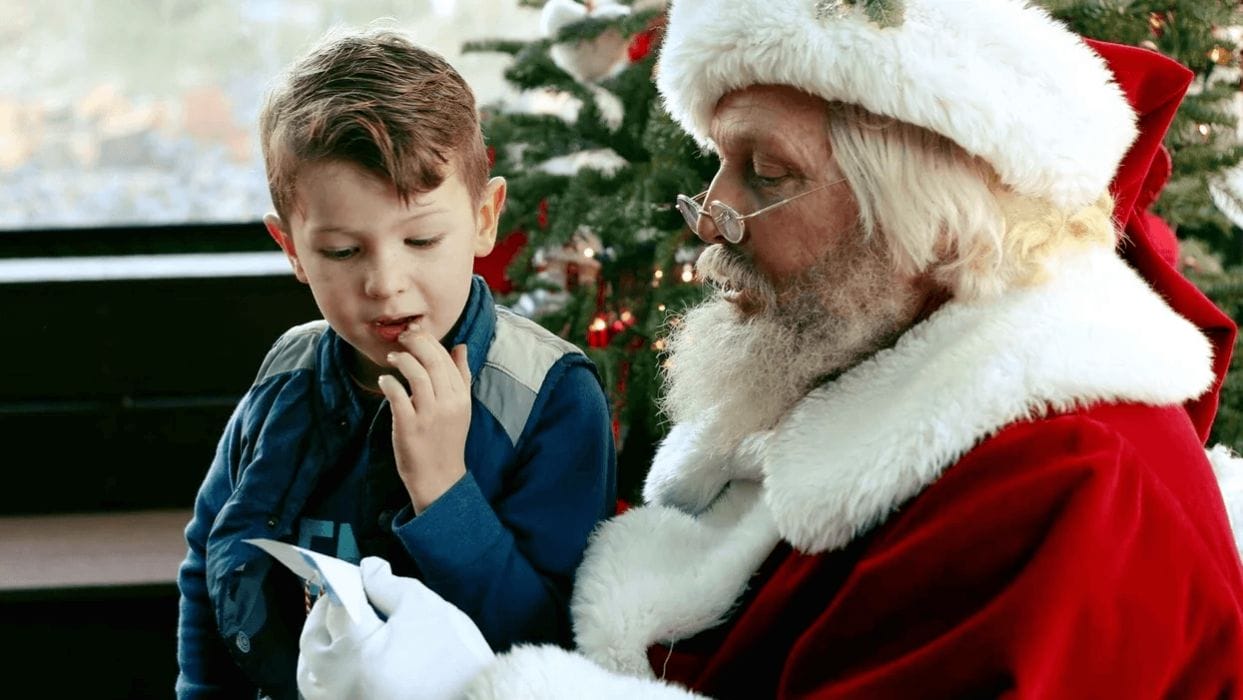 How to turn the Santa ‘lie’ into something good little boy sitting on Santa's lap- how to explain santa without lying