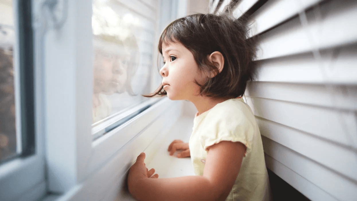 Corded window blinds have officially been banned for child safety little girl looking out window