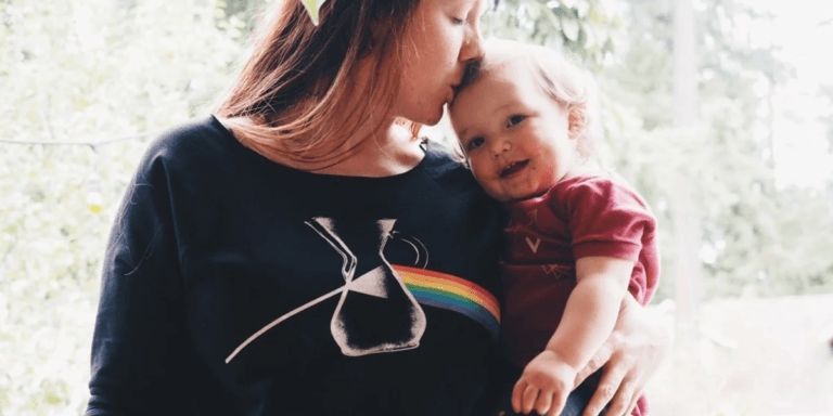 Mothers try to do the work of many, but one person does not make a village mom kissing baby on the head