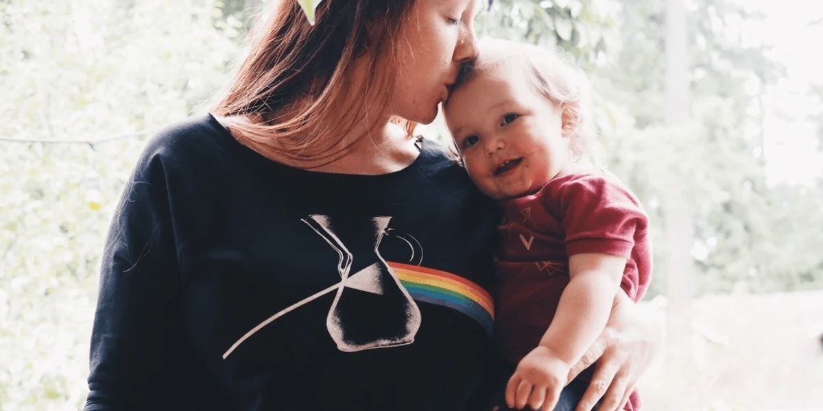 Mothers try to do the work of many, but one person does not make a village mom kissing baby on the head