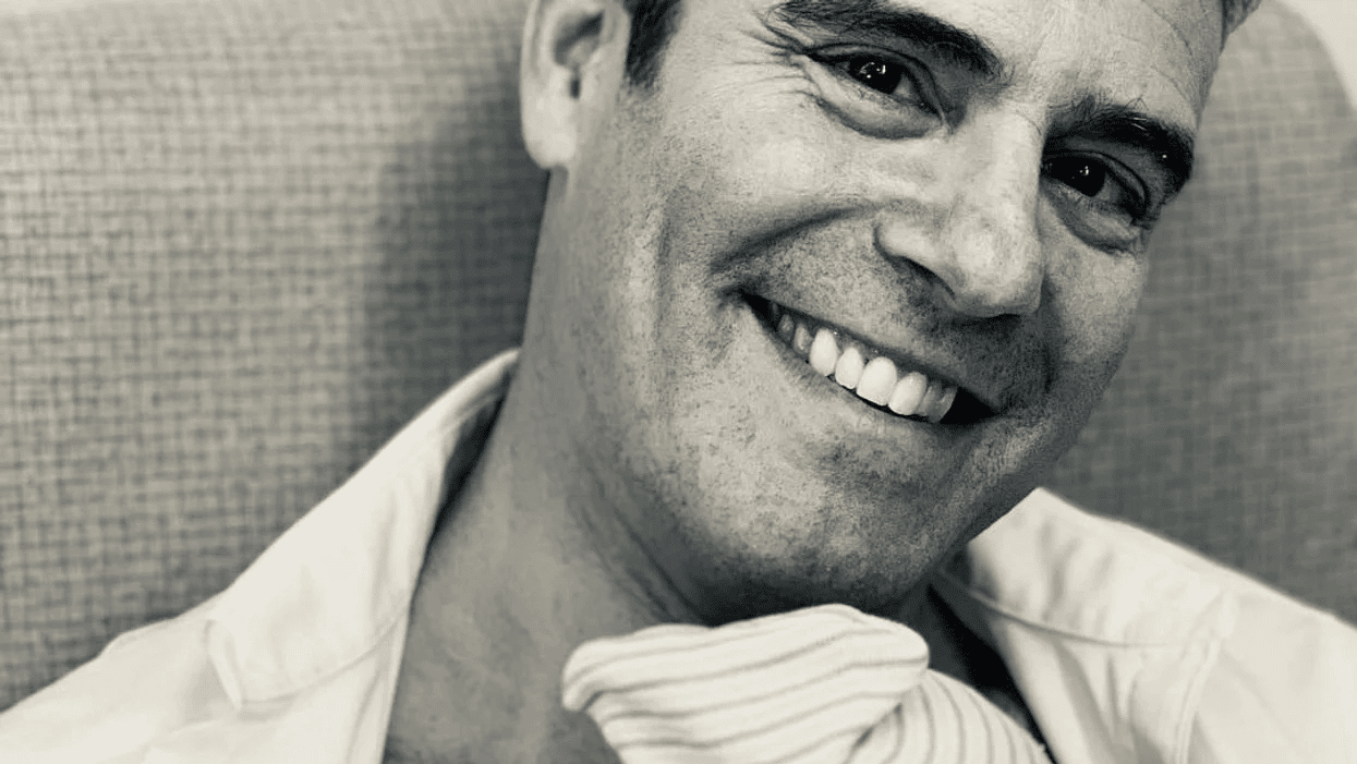 Andy Cohen just welcomed a baby boy! š black and white photo of Andy Cohen holding his new baby