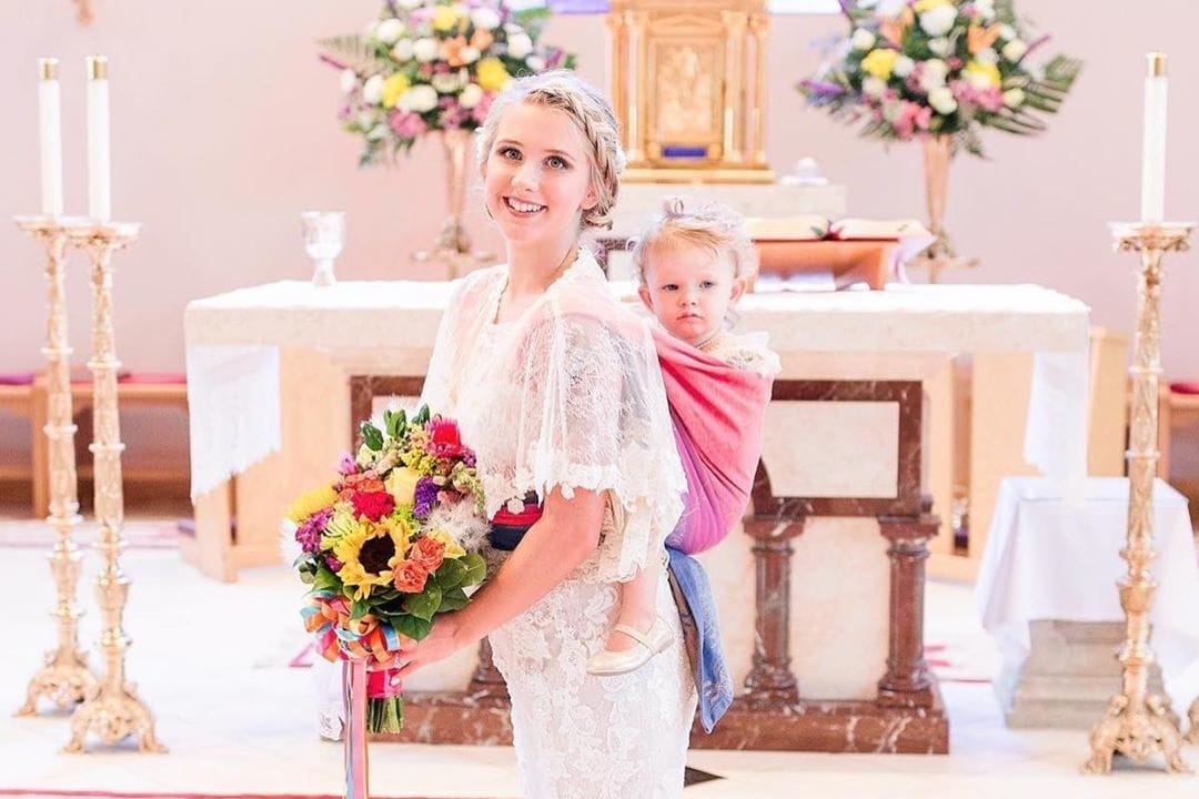 These viral photos of a mom wearing her toddler on her wedding day are