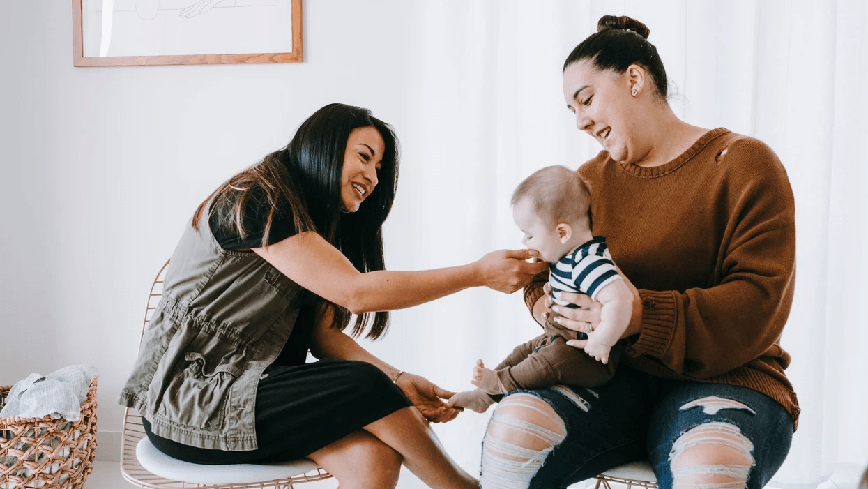 I wanted to find mom friends so I took the first step two moms playing with a toddler