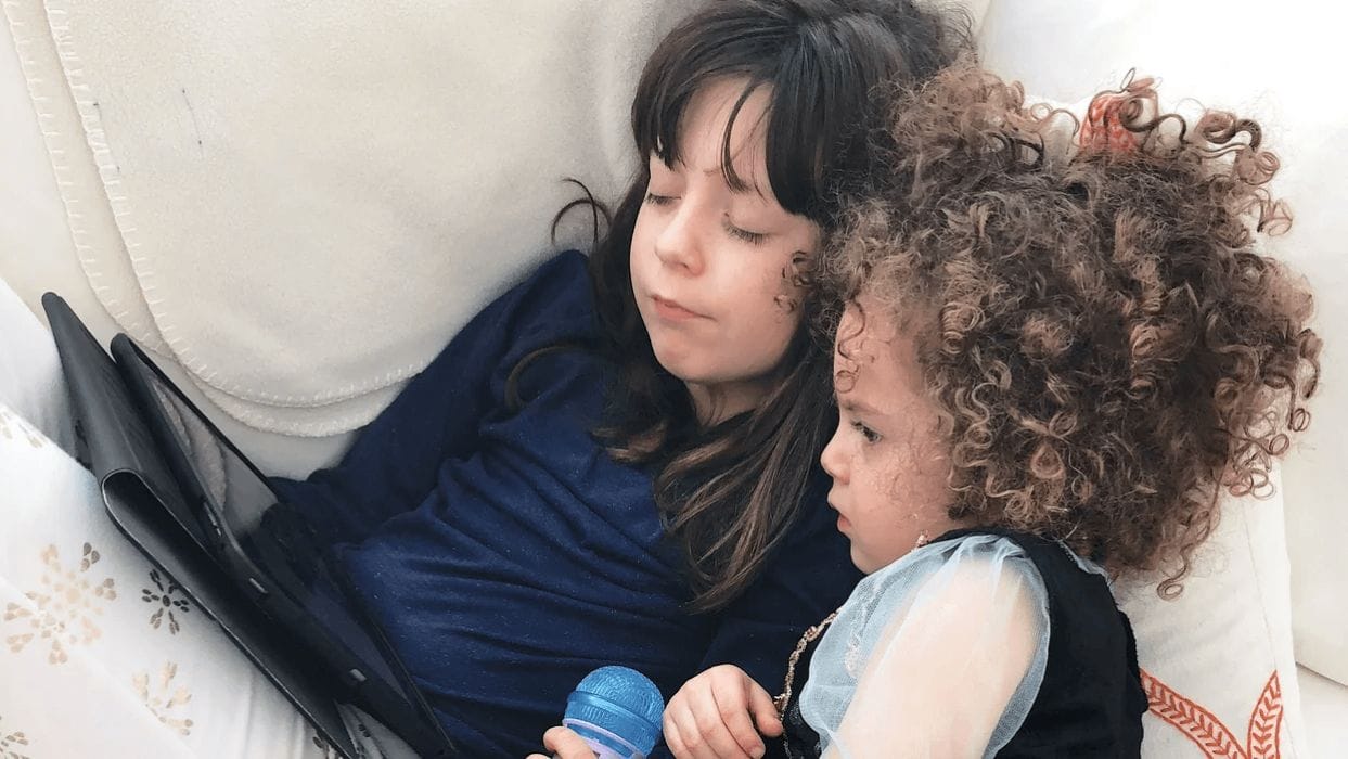 How to make the YouTube Kids app safer for your family two kids huddled together watching a tablet
