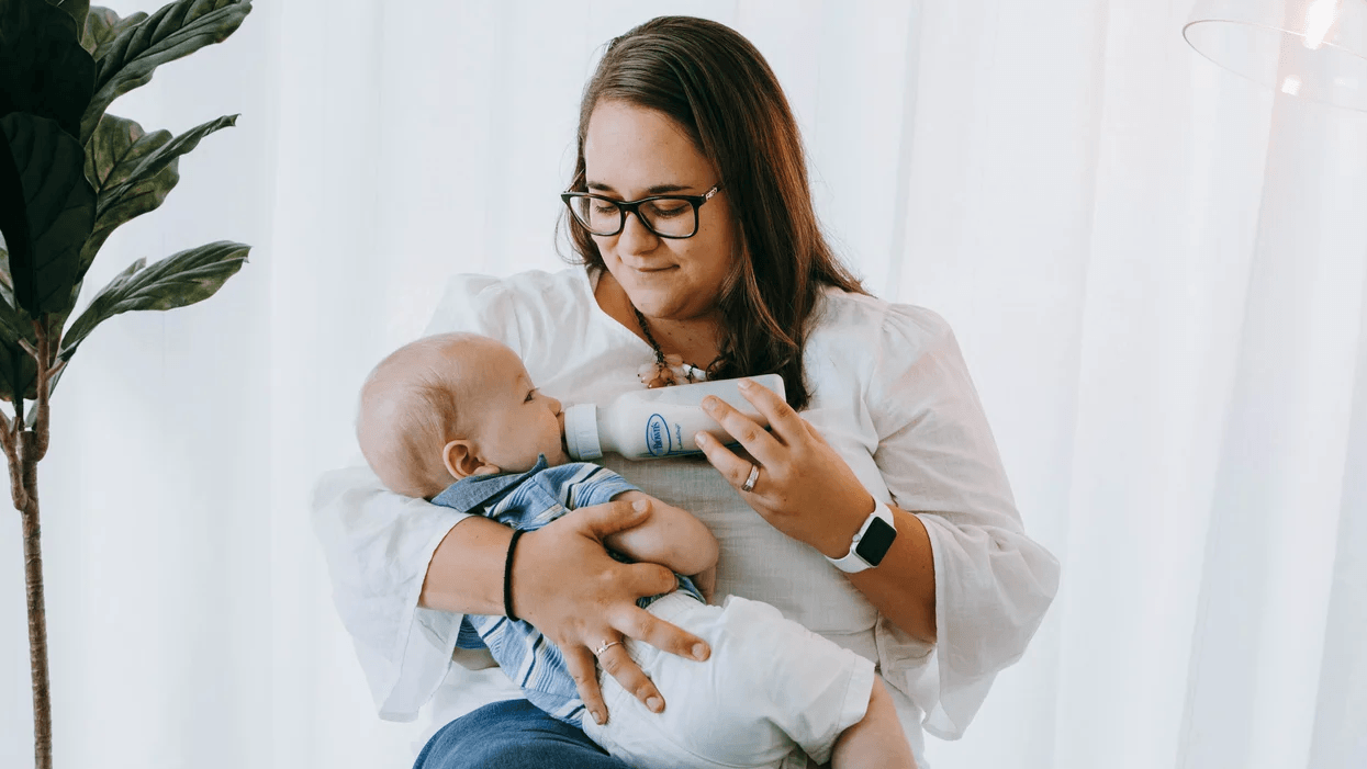 3 reasons why I’m letting go of bottle-feeding guilt mom giving a baby a bottle