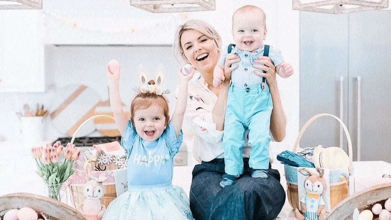 We’re obsessed with Ali Fedotowsky-Manno’s family Easter outfits—and you can get them at Target! Ali Fedotowsky-Manno holding her son while her daughter celebrates