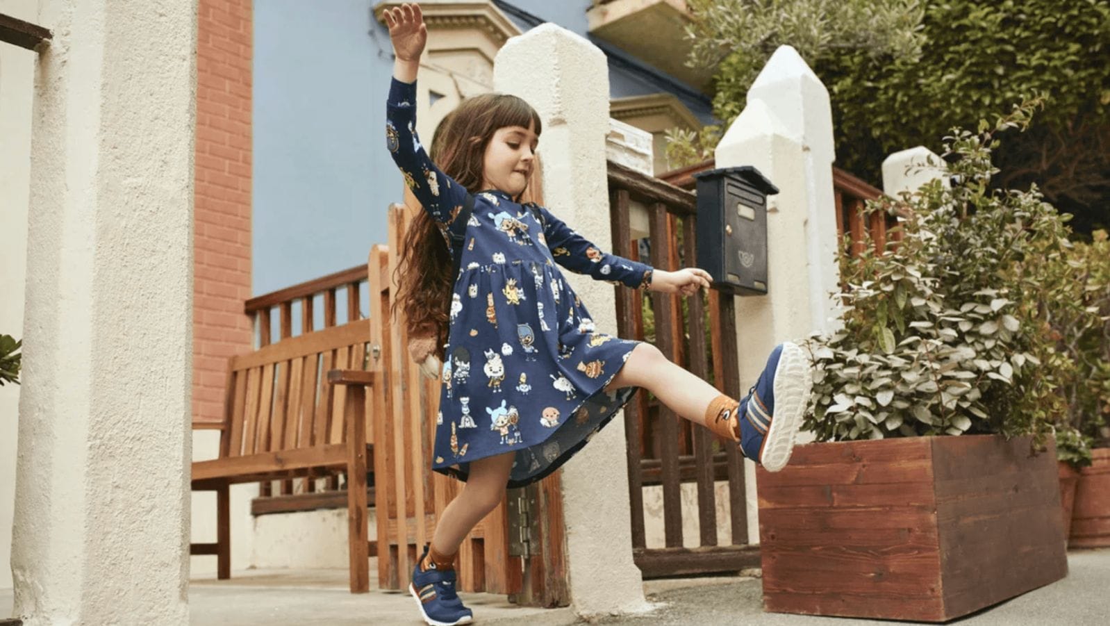 Our favorite 9 pieces from H&M to update your kid’s wardrobe for back to school little girl dancing wearing a backpack