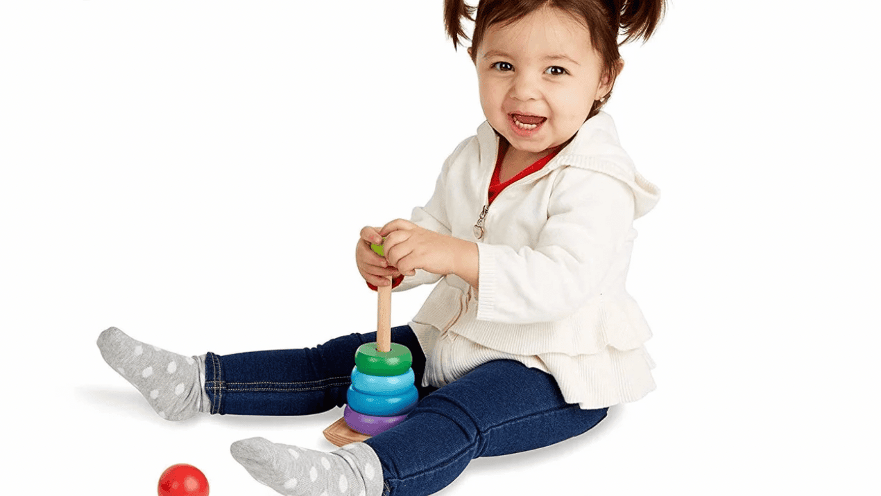 27 last-minute Montessori gifts on Amazon under $50 little girl playing with wooden rainbow stacking set
