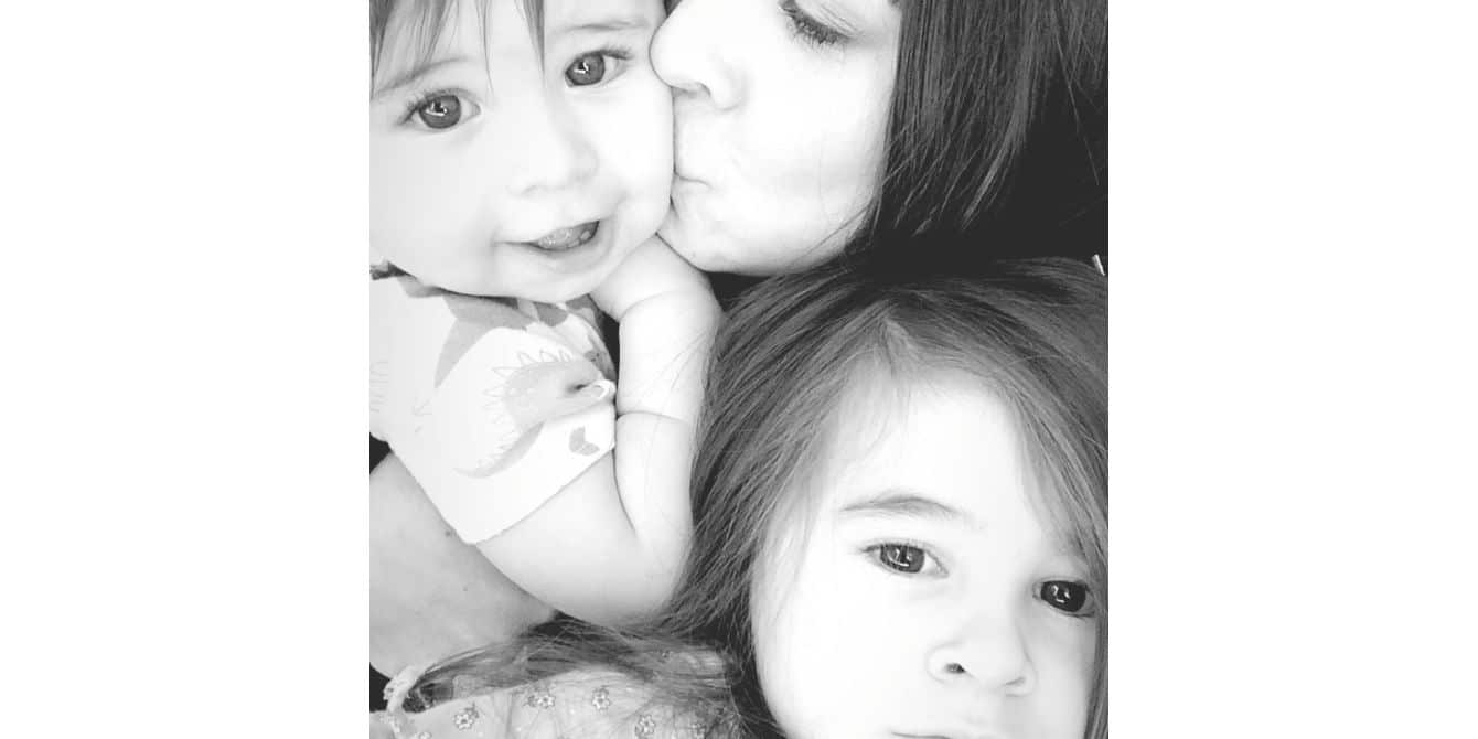 Brianne on being terrified to be home alone with her baby mom kissing a baby while her toddler snuggles her