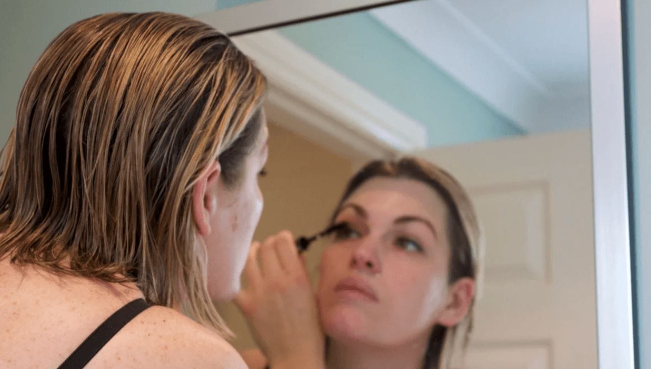 9 mascaras our editors use to make them instantly look more well-rested woman putting on mascara