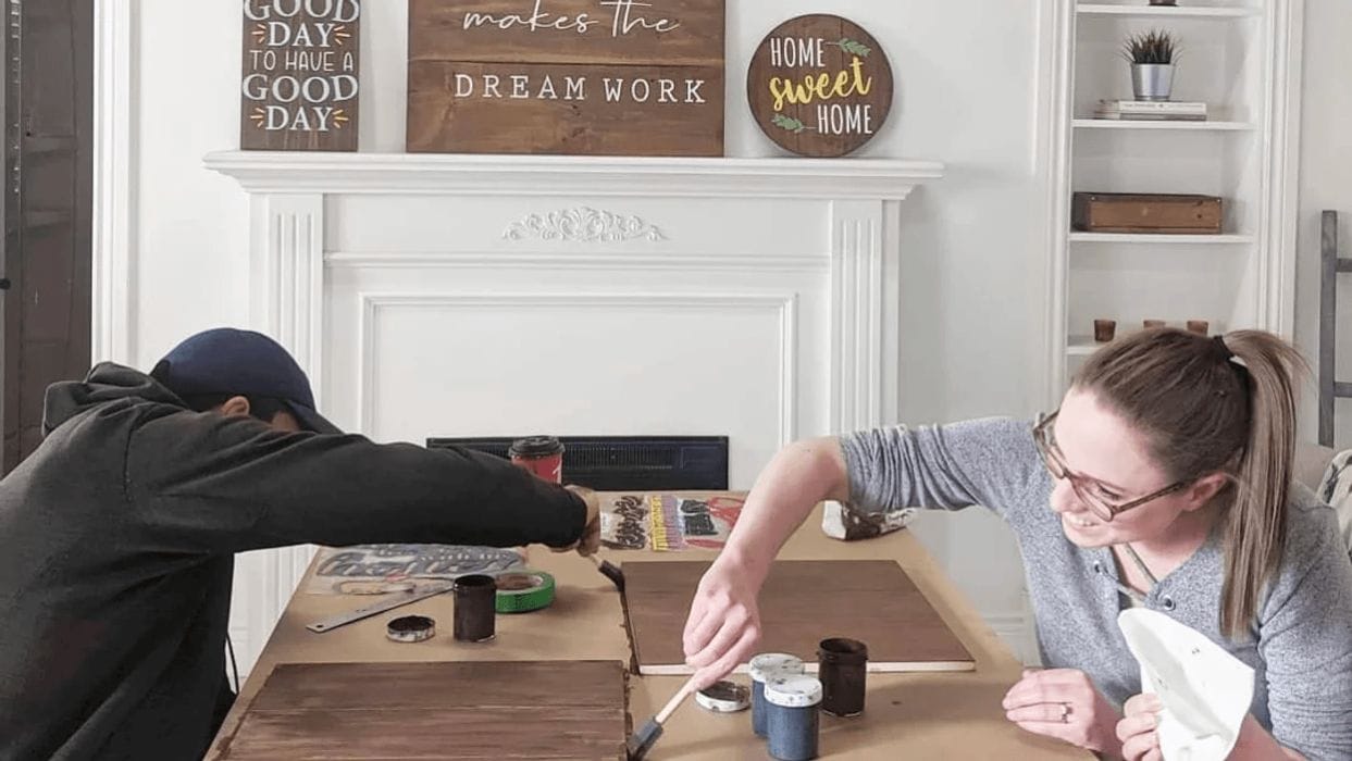 Give your home a spring refresh with these DIY decor projects (in under 10 minutes!) man and woman staining boards on cardboard