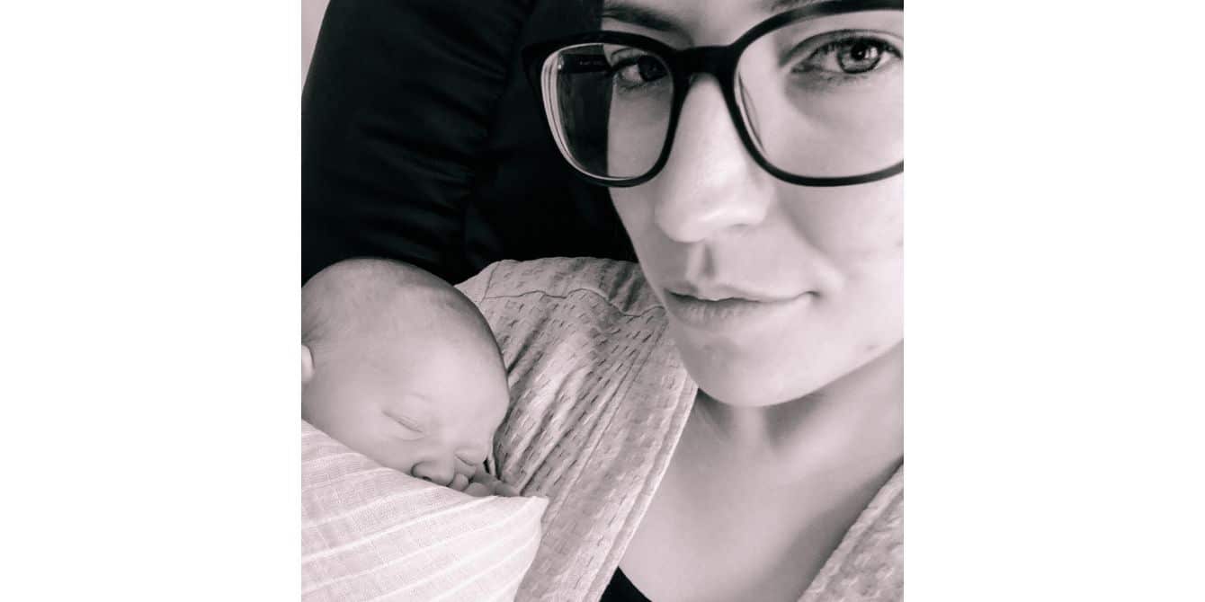 Kali on paying it forward after surviving postpartum depression selfie of a mom holding a newborn baby - essay on surviving postpartum depression