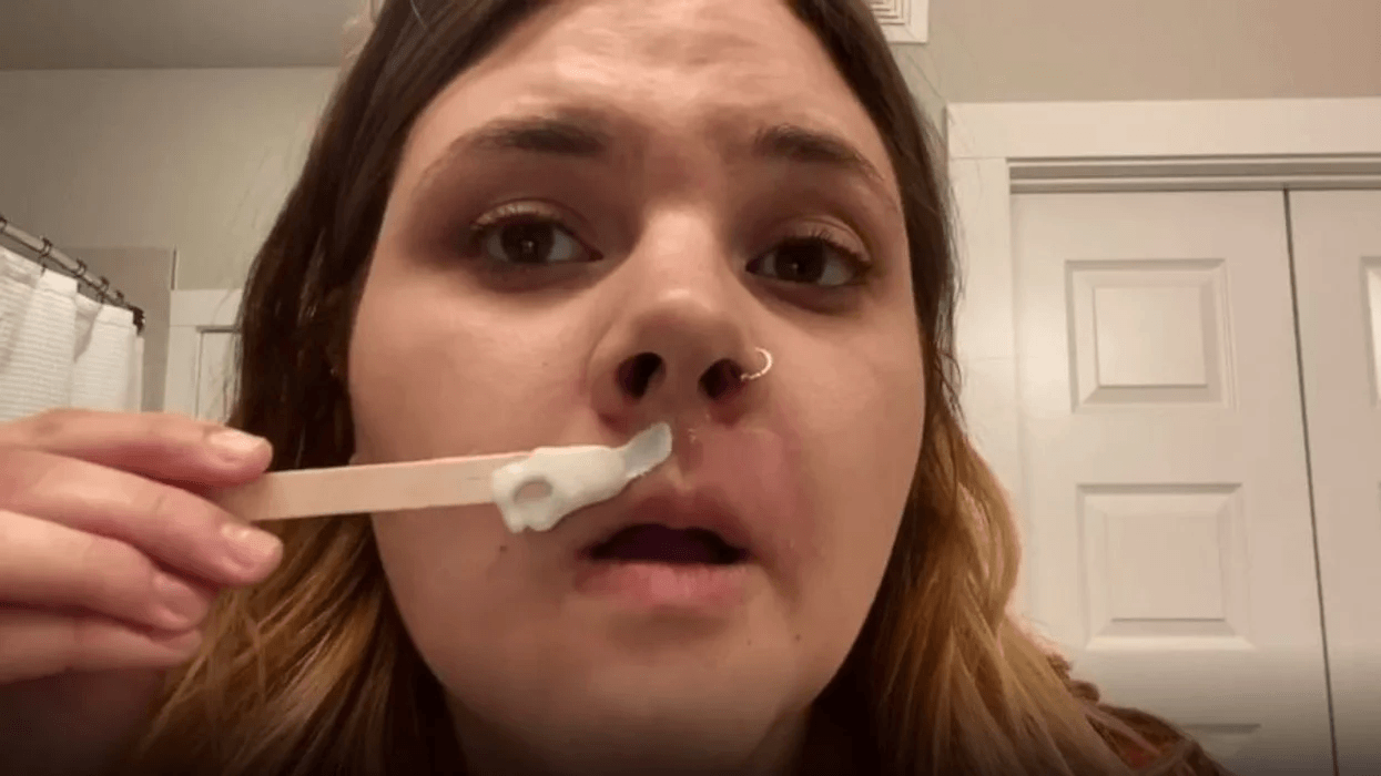 This viral at-home hair waxing video is so relatable (& so funny) close-up photo of woman waxing mustache