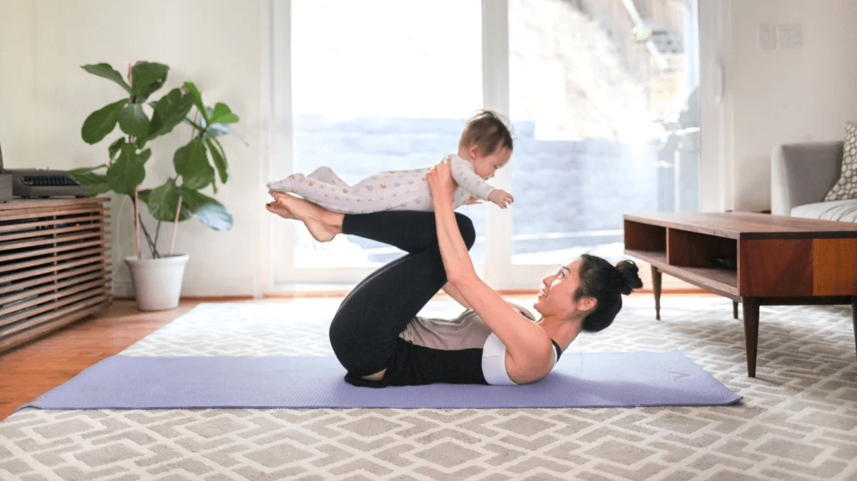 10+ free at-home workouts & fitness apps to get you moving, mama mom doing yoga with a baby