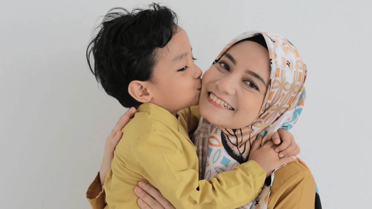25+ ways mamas are celebrating Mother’s Day this year son kissing mom on the cheek