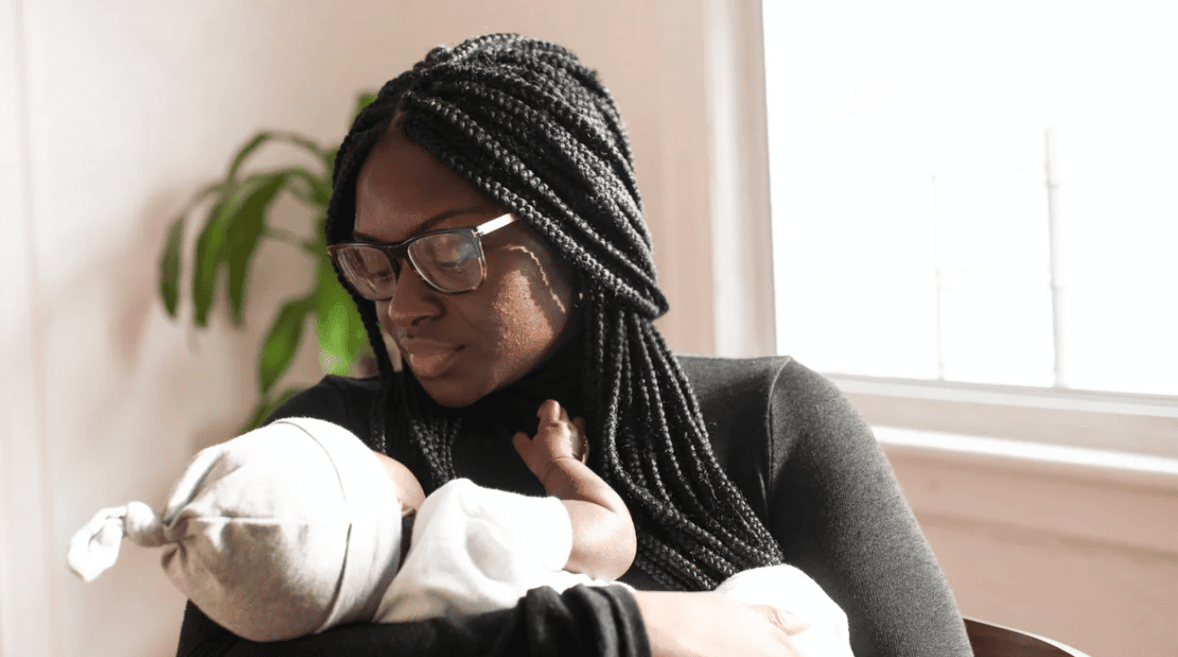 All the feels mom holding baby wearing a hat