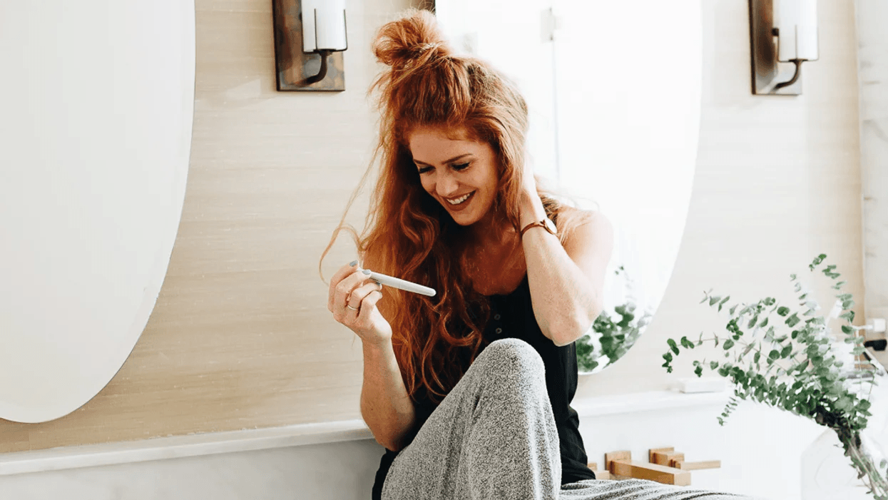 Trying to get pregnant? This brand will send you everything you need woman holding pregnancy test