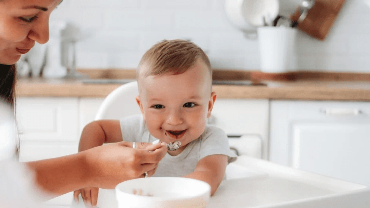 New baby & toddler feeding guidelines say no added sugar is best baby eating yogurt in a high chair