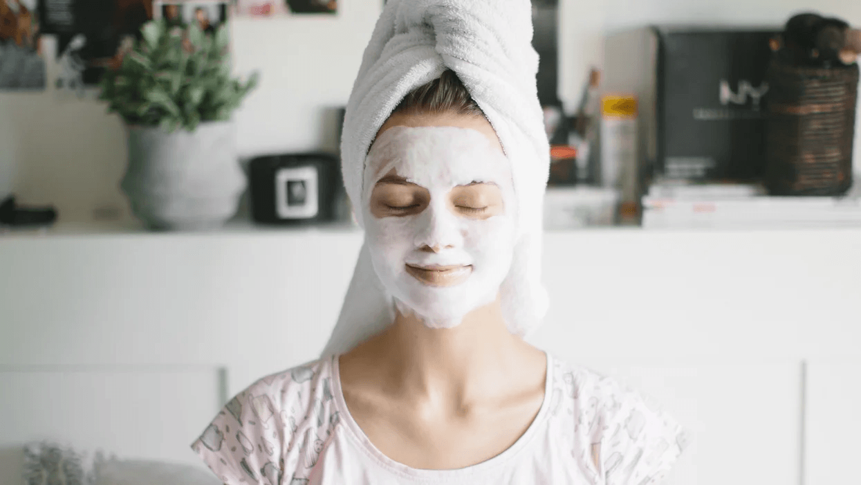 8 editor-approved beauty hacks every mama will love woman wearing a beauty mask with her hair in a towel