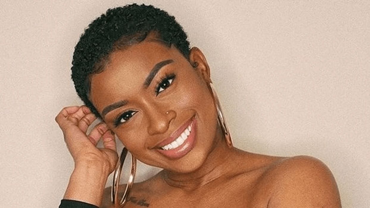 7 flattering hair trends mamas need to know woman running her hand through shaved head