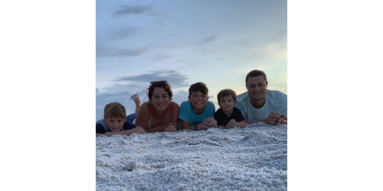 Krystal on postpartum depression leading her to confront her past traumas family laying on the beach sand - essay on how to confront past traumas